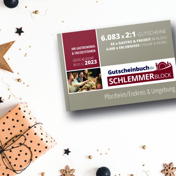 Served dinner table elegant arranged with Christmas decorations, rosemary wreath and gift box